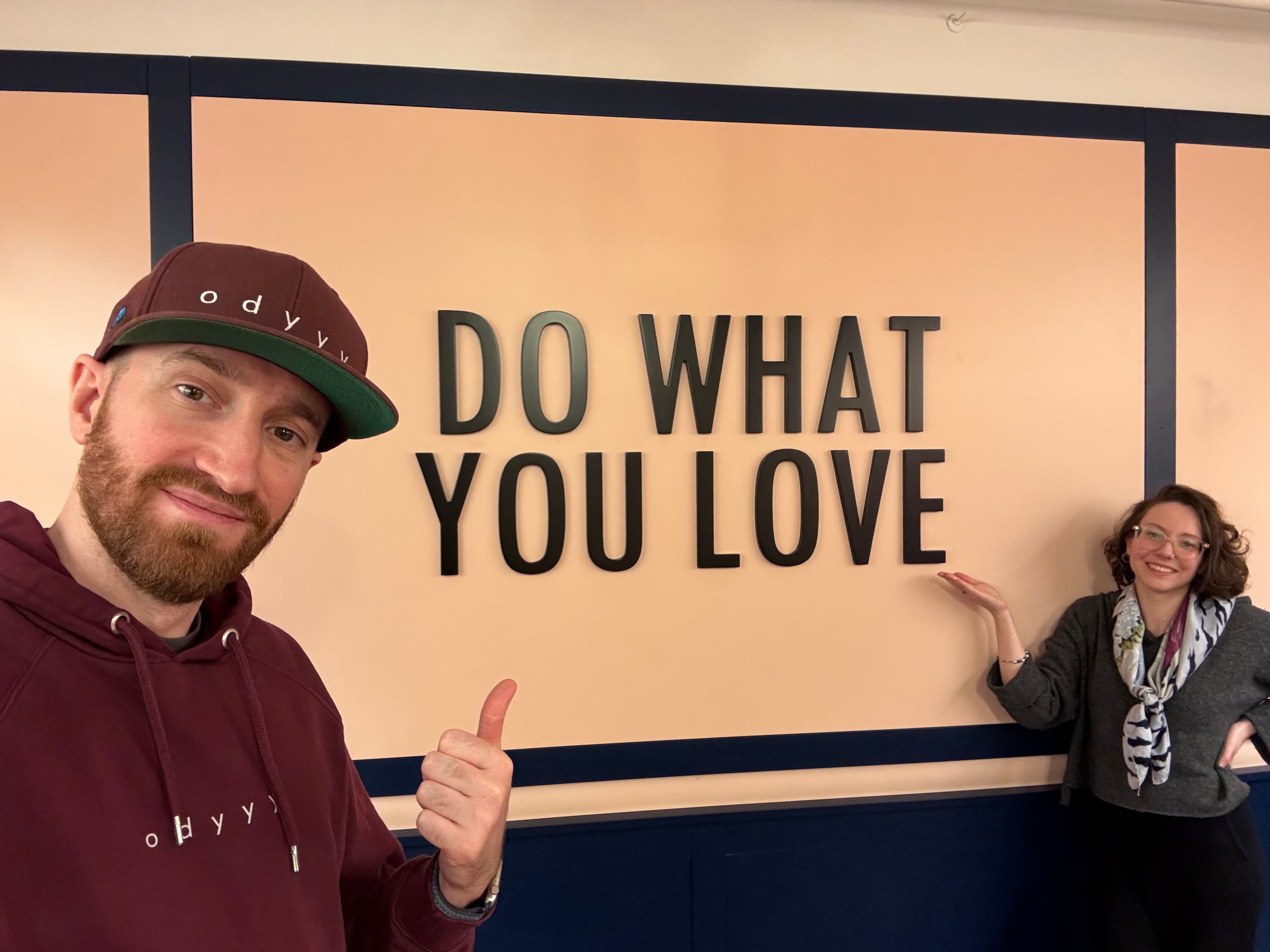 Laurent Loukopoulos and Rachel Desmoulins in front of a wall that reads Do what you love